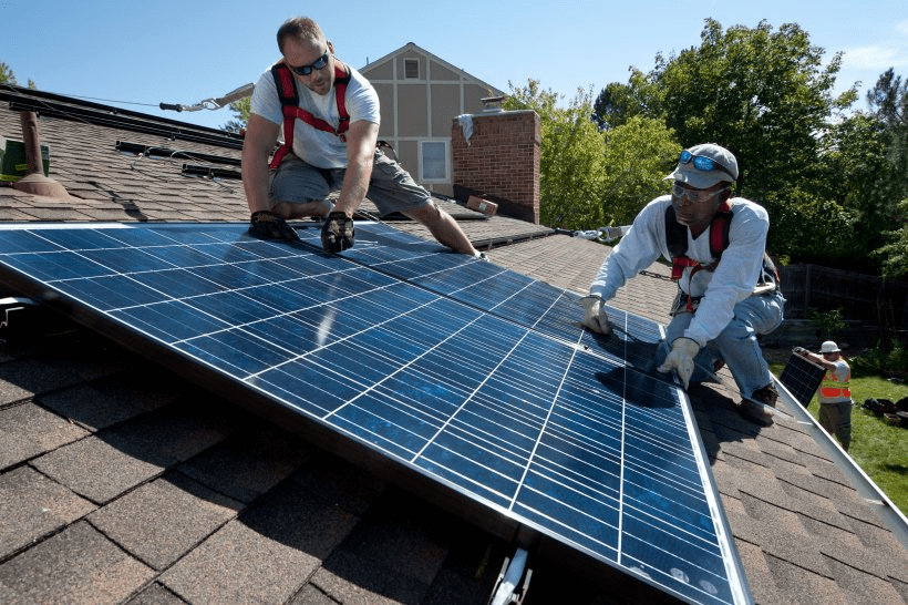 EV Sales: Photo of solar panel installation technicians